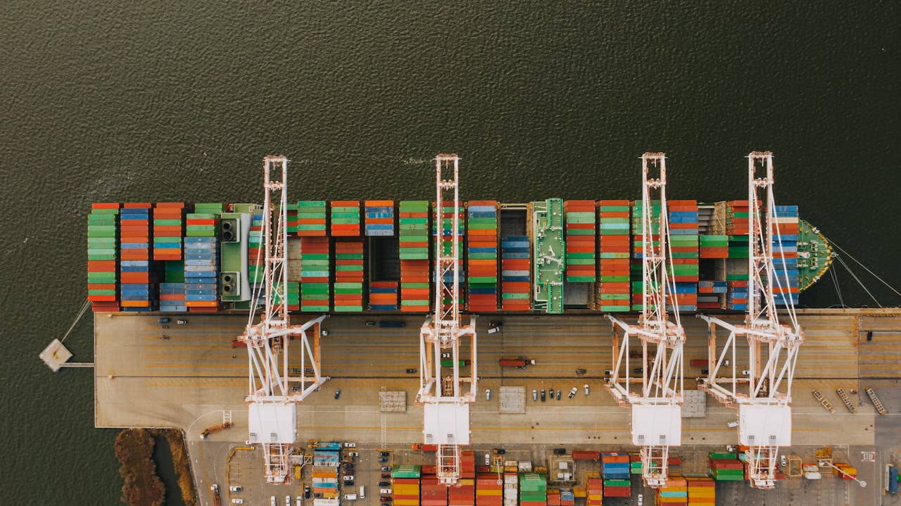 Overhead shot of colorful cargo containers and cranes at Baltimore's bustling port.